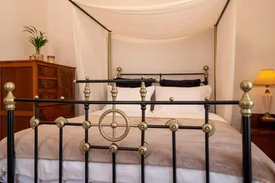 a bedroom with a black and gold bed at Le Nid The Nest of Beauty in Chania Town