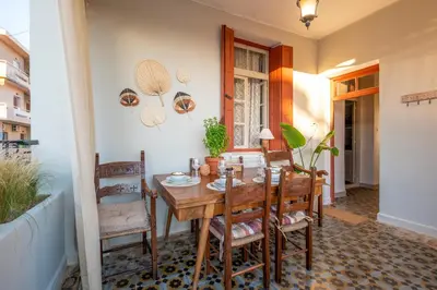 a dining room with a wooden table and chairs at Le Nid The Nest of Beauty in Chania Town