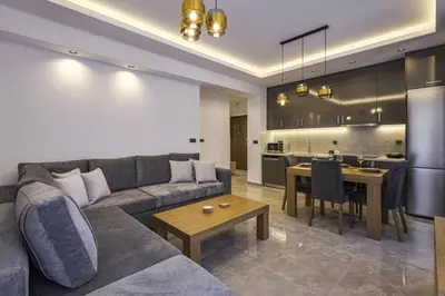 a living room with a couch and a table and a kitchen at Jimmis Apartment in Chania Town