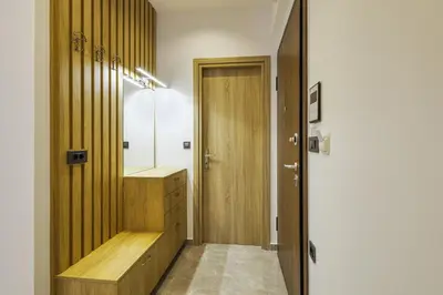 a bathroom with a wooden cabinet and a mirror at Jimmis Apartment in Chania Town