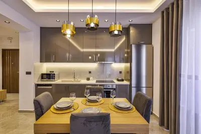 a dining room with a table and chairs and a kitchen at Jimmis Apartment in Chania Town
