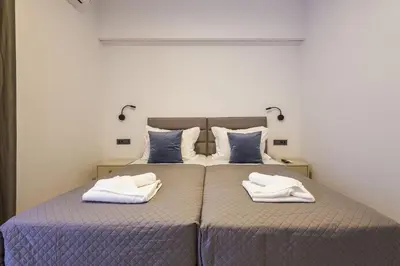 a bedroom with a bed with two towels on it at Jimmis Apartment in Chania Town