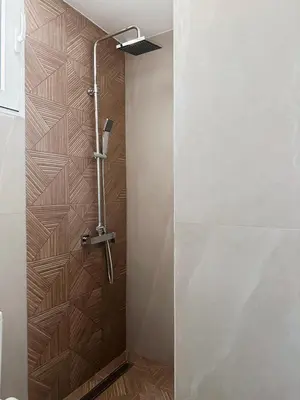 a shower with a glass door in a bathroom at Dida stone home in Chania Town