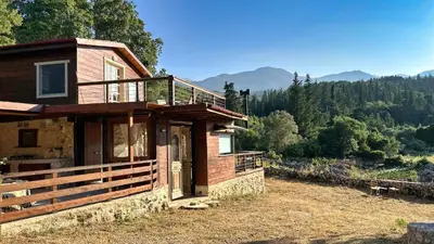 a house with a balcony on the side of it at The Root House - Crete Stay in Vafés