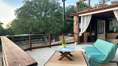 a patio with a bench and a table and a chair at The Root House - Crete Stay in Vafés