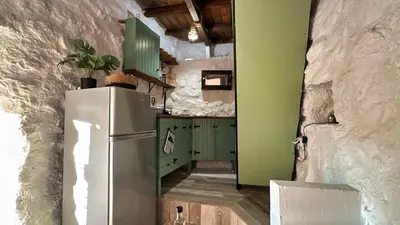 a kitchen with green cabinets and a refrigerator at The Root House - Crete Stay in Vafés