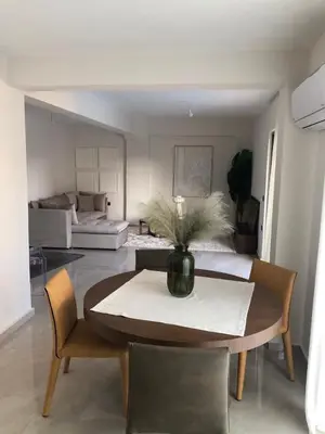 a dining room with a table with a vase on it at Casa del Sol - Kalathas in Kalathas