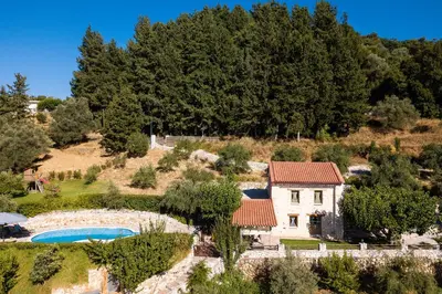an external view of a house and a swimming pool at Vrisali Traditional Stone Villa in Gerolakkos