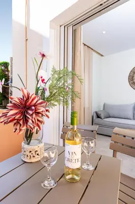 a bottle of wine on a table in a living room at Seatherial Apartments Paleochora in Palaiochóra