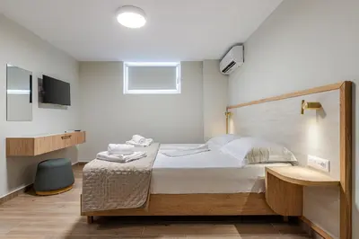 a bedroom with a large bed and a television at Seatherial Apartments Paleochora in Palaiochóra