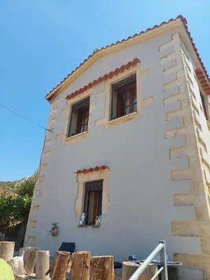 a house with two windows on the side of it at Casa Cretese Chania in Tsikalariá