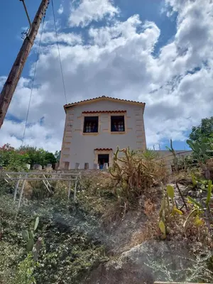 a small house on top of a hill at Casa Cretese Chania in Tsikalariá