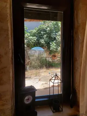 a window with a view of a garden outside at Casa Cretese Chania in Tsikalariá