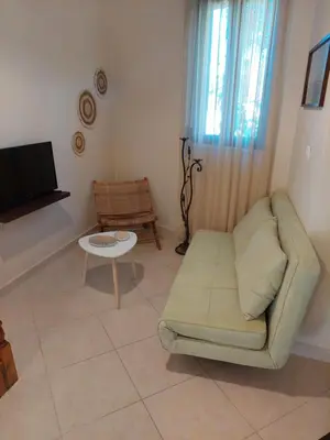 a living room with a couch and a tv at Casa Cretese Chania in Tsikalariá