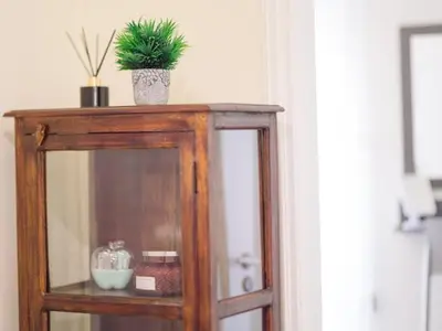 a wooden cabinet with a potted plant on top of it at Chania Charming Nest in Chania Town