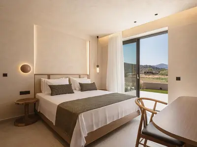 a bedroom with a bed and a large window at Onora Villa - Steps from the Sea by etouri in Nopíyia
