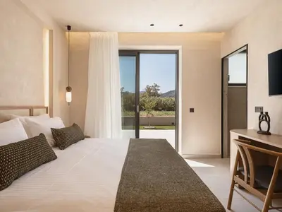 a bedroom with a large bed and a large window at Onora Villa - Steps from the Sea by etouri in Nopíyia
