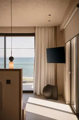 a living room with a large window with the ocean at Onora Villa - Steps from the Sea by etouri in Nopíyia