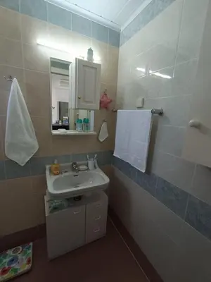 a bathroom with a sink and a mirror at Veranda with endless view in Fournés