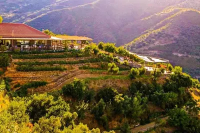 a building on top of a hill with a mountain at Veranda with endless view in Fournés