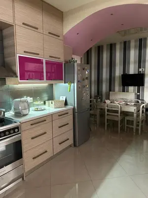 a kitchen with a stainless steel refrigerator and a table at Casa Emanuel in Chania Town