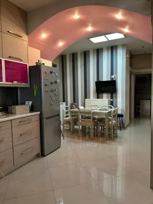 a kitchen and dining room with a table and a refrigerator at Casa Emanuel in Chania Town