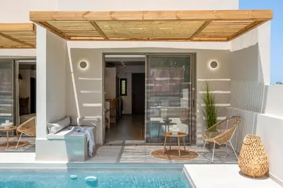 a house with a swimming pool and a patio at Aladdin Luxury Suites With Shared Pool in Galatás