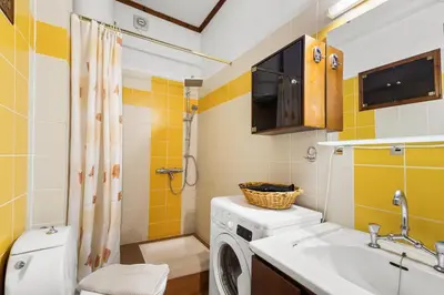 a bathroom with a washing machine and a sink at Spitatsi - Home with Yard in Chania Town