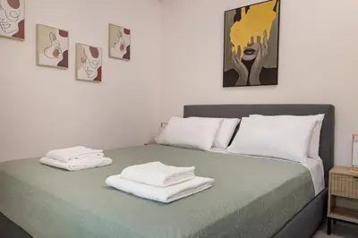 a bedroom with a bed with towels on it at Lum Urban Suites in Chania Town