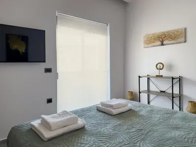 a bedroom with a bed with two towels on it at Lum Urban Suites in Chania Town