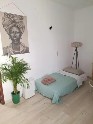 a bedroom with a bed and a painting on the wall at Menta Apartment's in Maleme