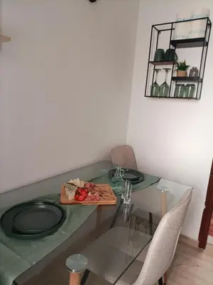 a glass table with a plate of food on it at Menta Apartment's in Maleme