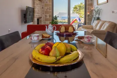 a plate of fruit on a table in a living room at ''Filoxenia'' of the 11 Brothers in Kissamos