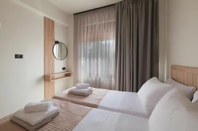 a bedroom with a large white bed with a window at Madre Tierra Boutique Villa 3 in Potistíria