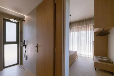 a room with a door to a bedroom with a window at Madre Tierra Boutique Villa 3 in Potistíria
