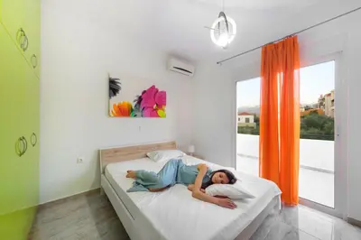 a child laying on a bed in a bedroom at Andreas Villa in Kato Daratso