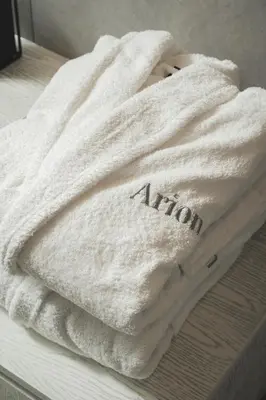 a white towel sitting on top of a bed at ES Apartments ARION in Chania Town