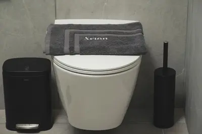a towel is sitting on top of a toilet at ES Apartments ARION in Chania Town