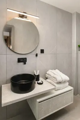 a bathroom with a black sink and a mirror at ES Apartments ARION in Chania Town