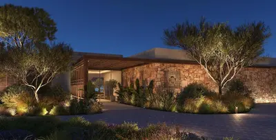 a brick house with trees and plants in front of it at Ikos Kissamos in Kissamos