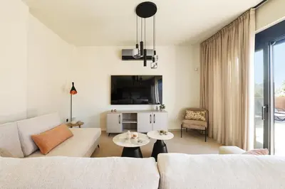 a living room with a couch and a table at Madre Tierra Boutique Villa 4 in Potistíria