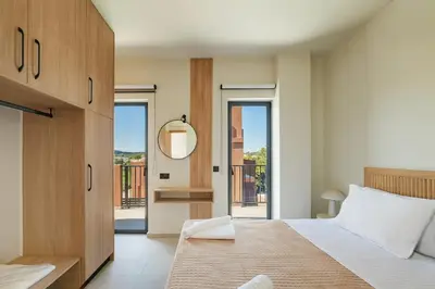 a bedroom with a large bed and a mirror at Madre Tierra Boutique Villa 4 in Potistíria