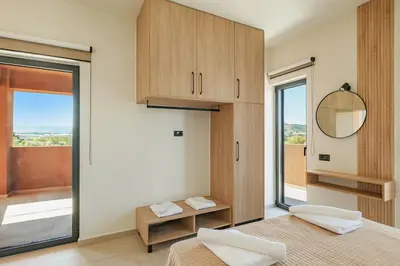 a bedroom with two beds and a mirror and a window at Madre Tierra Boutique Villa 4 in Potistíria