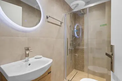 a bathroom with a sink and a shower at Seafront Apartment in Chania 6 in Chania Town