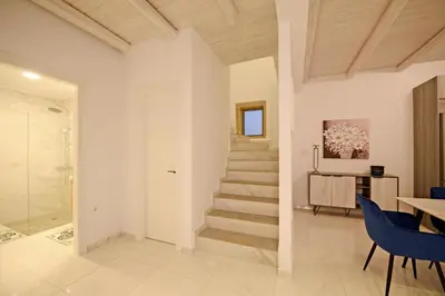 a hallway with a staircase in a house at Koukis Villa With Sea View in Falasarna