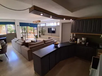 a kitchen and living room with a couch and a table at Diotima apartment in Chania Town