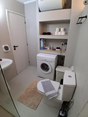 a bathroom with a toilet and a washing machine at Diotima apartment in Chania Town