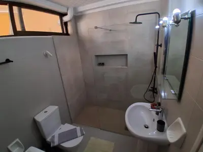 a bathroom with a shower and a toilet and a sink at Diotima apartment in Chania Town