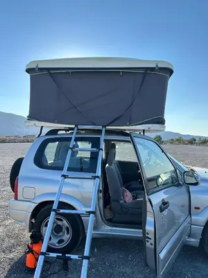 a car with a camper on top of it at Rooftop Jeep Escape Sleep Under the Stars in Chania Town