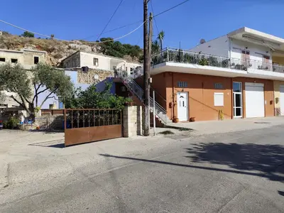 a building with a gate on the side of a street at Despoinas House in Plátanos